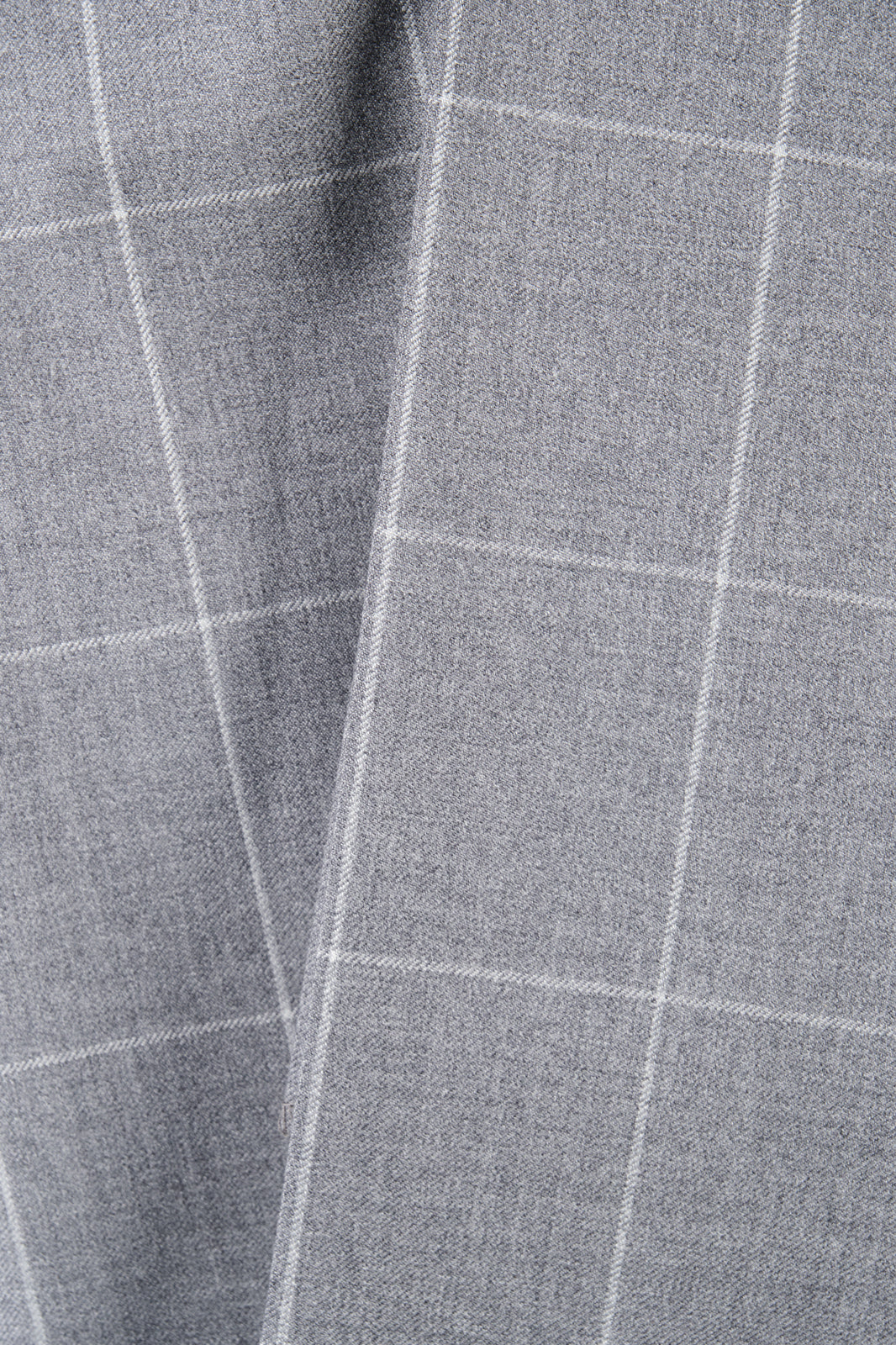 Zoom sur la matière du costume gris à carreaux.