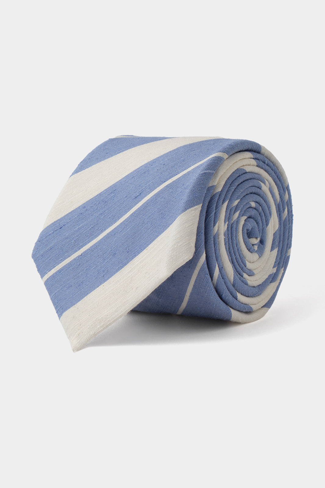 Vue sur fond blanc d'une cravate 100 % soie rayée - Blanche et bleue. 
Elle a 7,5 cm de largeur, 150 cm de longueur et est 100% soie effet lin.