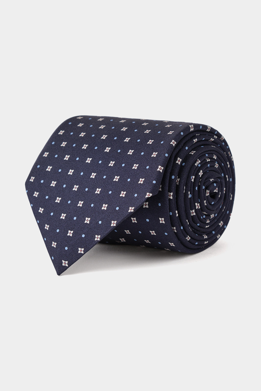 Cravate fabriquée en 100 % soie de couleur marine à motifs fleurs.