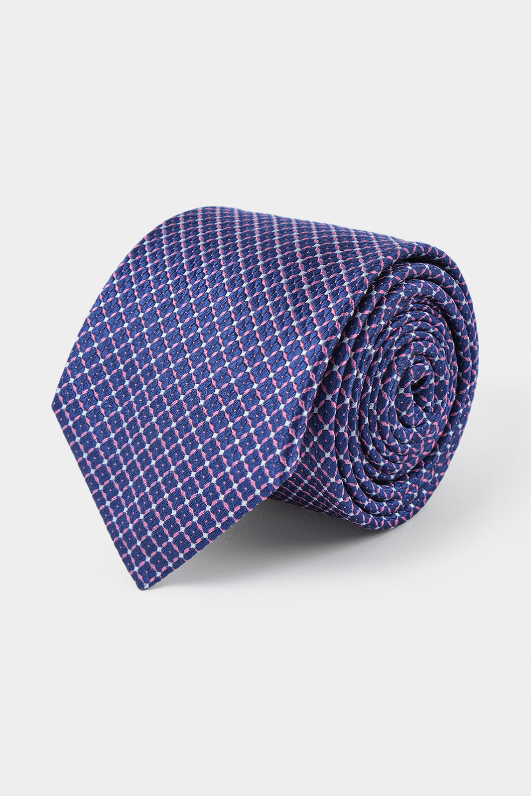 Vue sur fond blanc d'une cravate bleu à motifs géométriques rose en soie