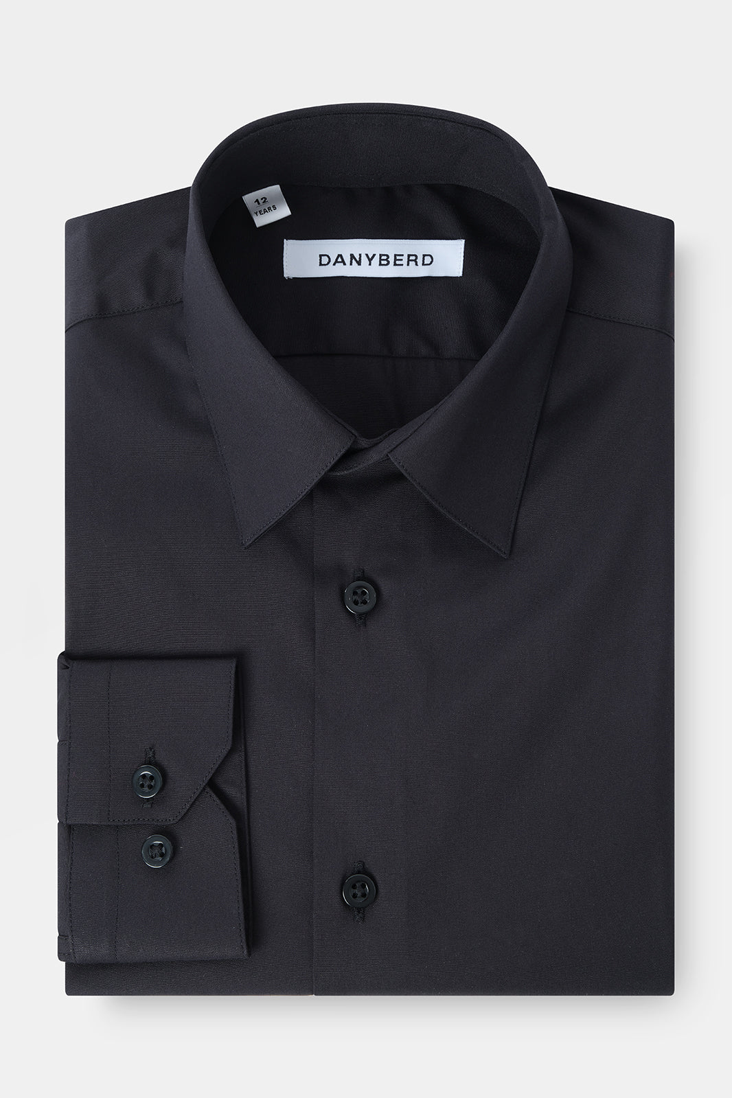 Vue sur fond blanc d'une chemise col couture noir pour enfant en coupe cintrée