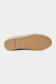 Vue de la semelle d'une espadrille en cuir beige .