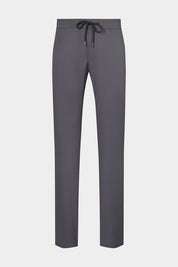 Vue sur fond blanc d'un pantalon jogpant en tissu technique de chez Olmetex gris avec poches zippés et cordons de serrage.