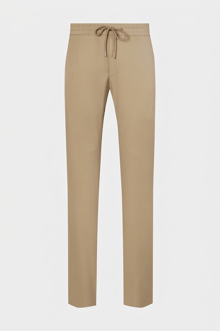 Vue sur fond blanc d'un pantalon jogpant technique poches zippées en Beige