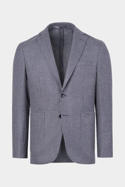 Vue sur fond blanc d'un blazer gris en laine et cachemire avec un tissu de chez E. Thomas. 