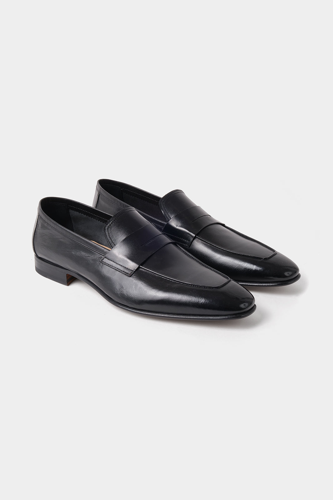 Vue sur fond blanc d'une paire de mocassins en cuir à bout carré en noir.