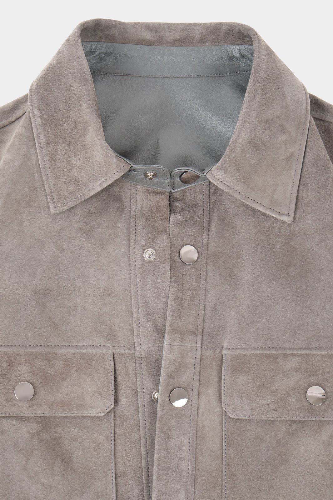 Vue du col sur fond blanc d'une surchemise en peau couleur anthracite avec poche poitrine et boutonnage pression.