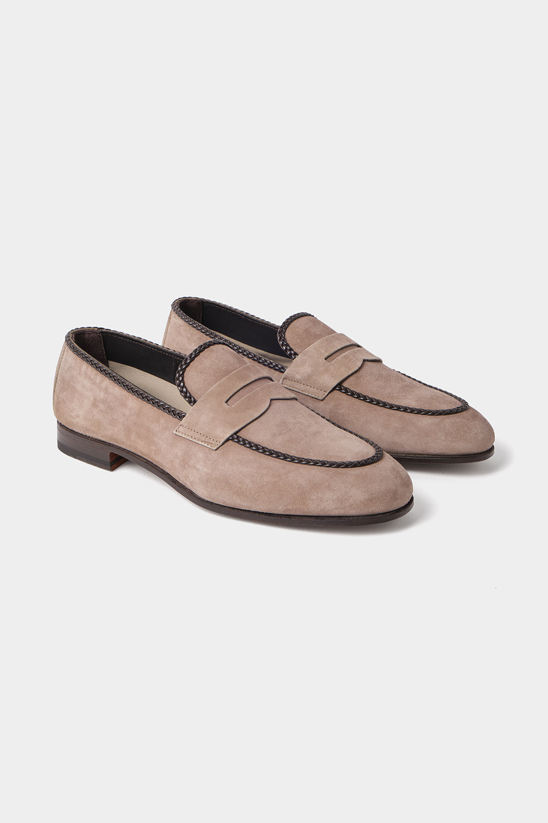 Vue sur fond blanc d'une paire de mocassins en daim en couleur taupe.