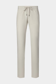 Vue sur fond blanc d'un pantalon jogpant technique poches zippées de coloris écru