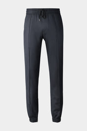 Vue sur fond d'un pantalon jogpant gris anthracite élastiqué et resséré,et zippé en bas de jambe 